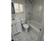 Bright bathroom with a shower-tub combo, modern vanity, and sleek marble-look tile flooring at 2027 E Michelle Dr, Phoenix, AZ 85022