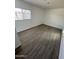 Bright bedroom with updated wood-look floors and freshly painted white walls at 2027 E Michelle Dr, Phoenix, AZ 85022