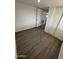 Clean, bright bedroom features wood-look floors and ample closet space at 2027 E Michelle Dr, Phoenix, AZ 85022