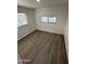 A bright bedroom with new wood floors and two windows providing natural light at 2027 E Michelle Dr, Phoenix, AZ 85022