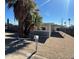 Charming single-story home featuring desert landscaping, a covered carport and mature palm trees at 2027 E Michelle Dr, Phoenix, AZ 85022