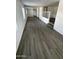 Open-concept living room with wood-look flooring, white walls, and abundant natural light at 2027 E Michelle Dr, Phoenix, AZ 85022