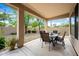 Covered back patio with dining set, offering a comfortable and shaded outdoor living space at 2069 S Sailors Ct, Gilbert, AZ 85295