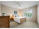 Comfortable bedroom with a ceiling fan, natural light from the window, and a charming neutral color palette at 2069 S Sailors Ct, Gilbert, AZ 85295