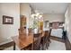 Formal dining room with hardwood floors and chandelier, adjacent to open kitchen at 2069 S Sailors Ct, Gilbert, AZ 85295