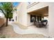 Home exterior features a covered back patio with a dining set and manicured landscaping at 2069 S Sailors Ct, Gilbert, AZ 85295