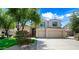 Charming two-story home with a well-manicured front yard, complemented by a beautiful flowering tree at 2069 S Sailors Ct, Gilbert, AZ 85295