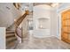 Elegant foyer with a curved staircase and decorative niche welcomes you into this beautiful home at 2069 S Sailors Ct, Gilbert, AZ 85295