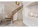 Staircase with carpeted steps, a light wall niche, and tile flooring that leads into the hallway at 2069 S Sailors Ct, Gilbert, AZ 85295