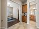 Hallway view featuring doors to the office and bathroom, with wood cabinets in the hallway at 2069 S Sailors Ct, Gilbert, AZ 85295