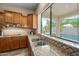 Gourmet kitchen with stainless steel sink and granite countertops, with views of the pool at 2069 S Sailors Ct, Gilbert, AZ 85295