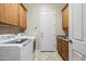 Laundry room with modern washer and dryer, built-in cabinets, and a convenient utility sink at 2069 S Sailors Ct, Gilbert, AZ 85295
