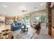 Cozy living room features a stone fireplace, hardwood floors, and opens to a modern kitchen at 2069 S Sailors Ct, Gilbert, AZ 85295