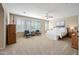 Spacious main bedroom with a seating area, large windows, and plush carpet at 2069 S Sailors Ct, Gilbert, AZ 85295