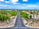 Scenic street view with lush landscaping, decorative entrance monuments, and neighborhood entry at 2069 S Sailors Ct, Gilbert, AZ 85295