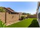 Turf backyard with green landscaping, brick wall, and low maintenance design at 20698 W Meadowbrook Ave, Buckeye, AZ 85396