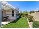 Beautiful backyard with artificial grass, a pergola, and blooming bushes along the fence at 20698 W Meadowbrook Ave, Buckeye, AZ 85396