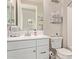 Bathroom featuring a white vanity, toilet, mirror and decorative towels and art at 20698 W Meadowbrook Ave, Buckeye, AZ 85396