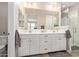 Bathroom with double vanity, large mirror, and glass-enclosed shower at 20698 W Meadowbrook Ave, Buckeye, AZ 85396