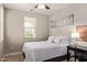 Comfortable bedroom with a ceiling fan, a window, and modern decor at 20698 W Meadowbrook Ave, Buckeye, AZ 85396