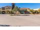 Inviting clubhouse entrance featuring desert landscaping and modern Southwestern architecture with a towering stone tower at 20698 W Meadowbrook Ave, Buckeye, AZ 85396