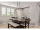 Stylish dining area bathed in natural light, featuring a modern table, bench seating, and pendant lighting at 20698 W Meadowbrook Ave, Buckeye, AZ 85396