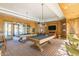 Game room with pool tables, TVs, comfortable seating, and a festive atmosphere at 20698 W Meadowbrook Ave, Buckeye, AZ 85396
