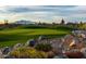 Beautiful golf course with strategically placed rock features and desert flora for a challenging and scenic game at 20698 W Meadowbrook Ave, Buckeye, AZ 85396