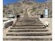 Rugged hiking trail with sturdy wooden stairs ascending through the desert landscape towards the mountain peak at 20698 W Meadowbrook Ave, Buckeye, AZ 85396