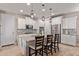 Modern kitchen features stainless steel appliances, an island with seating, and decorative pendant lighting at 20698 W Meadowbrook Ave, Buckeye, AZ 85396