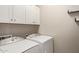 Laundry room featuring a new-looking washer and dryer and plenty of cabinet space at 20698 W Meadowbrook Ave, Buckeye, AZ 85396