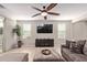 Cozy living area featuring a large television, modern furniture, and a decorative potted plant at 20698 W Meadowbrook Ave, Buckeye, AZ 85396