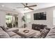 Comfortable living area featuring a large television, modern furniture, and a glass sliding door to the backyard at 20698 W Meadowbrook Ave, Buckeye, AZ 85396