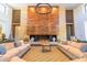 Clubhouse lounge area with modern sofas, a fireplace, and stylish decor at 20698 W Meadowbrook Ave, Buckeye, AZ 85396