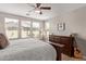 Bright main bedroom with wood flooring, large windows, ceiling fan and neutral colors at 20698 W Meadowbrook Ave, Buckeye, AZ 85396