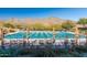 Community pool with lane dividers, mountain views, lounge chairs and plenty of space for swimming at 20698 W Meadowbrook Ave, Buckeye, AZ 85396