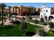 Charming street view featuring lush landscaping and attractive commercial buildings with Southwestern architectural details at 20698 W Meadowbrook Ave, Buckeye, AZ 85396
