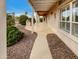 Covered back patio with a built-in grill and landscaped yard, perfect for outdoor entertaining at 2088 N 164Th Ave, Goodyear, AZ 85395