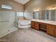 Large bathroom featuring a glass shower, soaking tub, and dual sink vanity at 2088 N 164Th Ave, Goodyear, AZ 85395