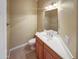 Powder room featuring a wooden vanity, white sink, and neutral wall color at 2088 N 164Th Ave, Goodyear, AZ 85395