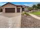 Charming single-story home with a well-manicured lawn, brown roof, and wide driveway at 2088 N 164Th Ave, Goodyear, AZ 85395