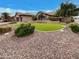 Attractive home exterior featuring manicured landscaping, decorative rocks, and an artificial grass accent at 2088 N 164Th Ave, Goodyear, AZ 85395