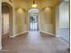 Elegant hallway featuring arched entryways, tiled flooring, and decorative wall niches at 2088 N 164Th Ave, Goodyear, AZ 85395