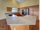 Bright kitchen with a granite countertop, stainless steel appliances, and natural wooden cabinets at 2088 N 164Th Ave, Goodyear, AZ 85395