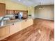 Bright kitchen features stainless steel appliances, ample granite counters, and hardwood floors at 2088 N 164Th Ave, Goodyear, AZ 85395