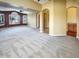 Spacious living area featuring an open layout, neutral carpet, and arched doorways to other rooms at 2088 N 164Th Ave, Goodyear, AZ 85395