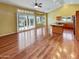 Open-concept living area featuring hardwood floors, a kitchen with bar, and access to a patio at 2088 N 164Th Ave, Goodyear, AZ 85395