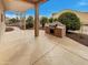 A covered patio includes an outdoor kitchen area with stone floors and plenty of space for entertaining at 2088 N 164Th Ave, Goodyear, AZ 85395