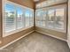 Cozy sunroom with neutral carpet and windows offering views of the landscaped yard at 2088 N 164Th Ave, Goodyear, AZ 85395
