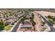 Aerial view showcasing a single-story home surrounded by a meticulously landscaped yard, a walking path and neighborhood homes at 20941 E Pecan Ln, Queen Creek, AZ 85142